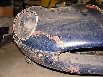 Jaguar. Chipped paint and rust before restoration and painting.